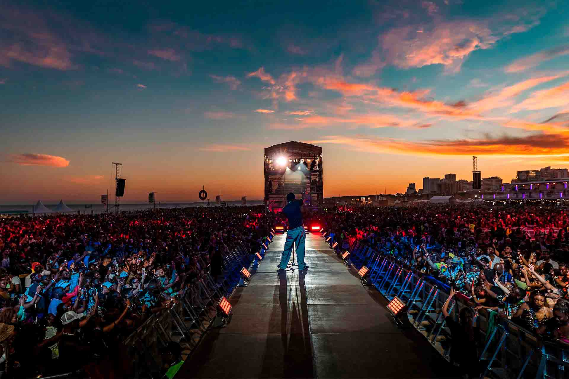 Vibrant African music festival crowd at sunset