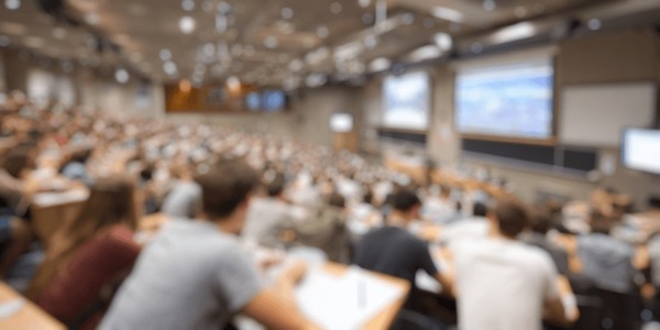 Modern university lecture hall, bright natural light, diverse students paying attention to a presentation, high quality photography