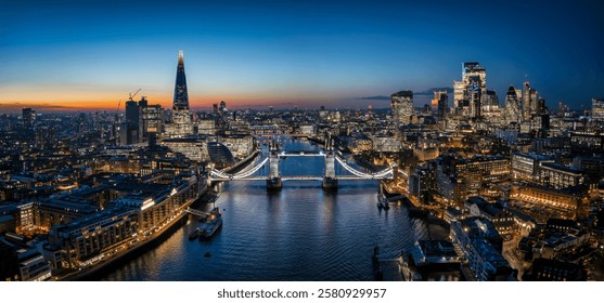 Beautiful panorama of London Thames skyline at dusk with lights on