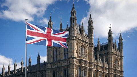 Westminster Palace and Big Ben with Union Jack flags, sunny day