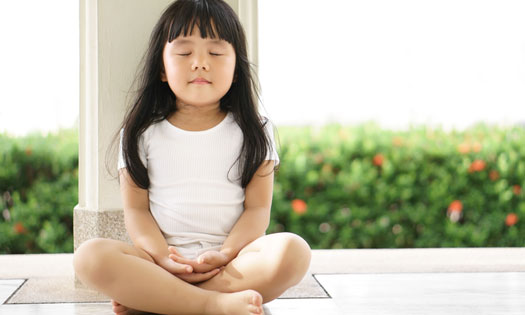 Child practicing breathing or grounding exercise preschool