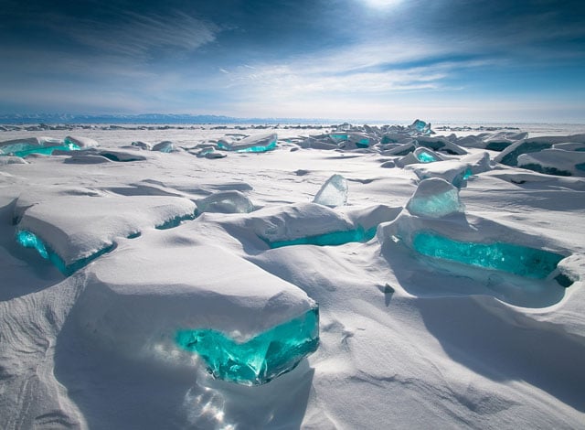 Lake Baikal in winter with clear turquoise ice blocks, photorealistic
