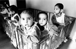 Romanian orphanage 1989 empty cribs documentary style black and white