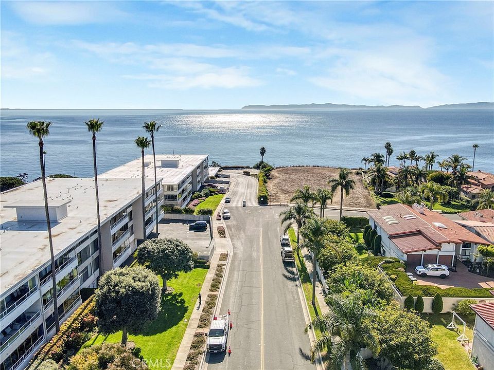 View of Palos Verdes Peninsula and Catalina Island from an elevated modern Los Angeles home balcony, clear day, photorealistic