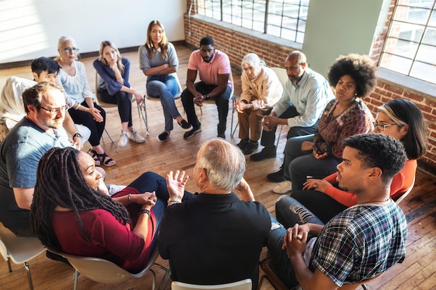 group of diverse young adults sitting in a circle discussion, community center vibe
