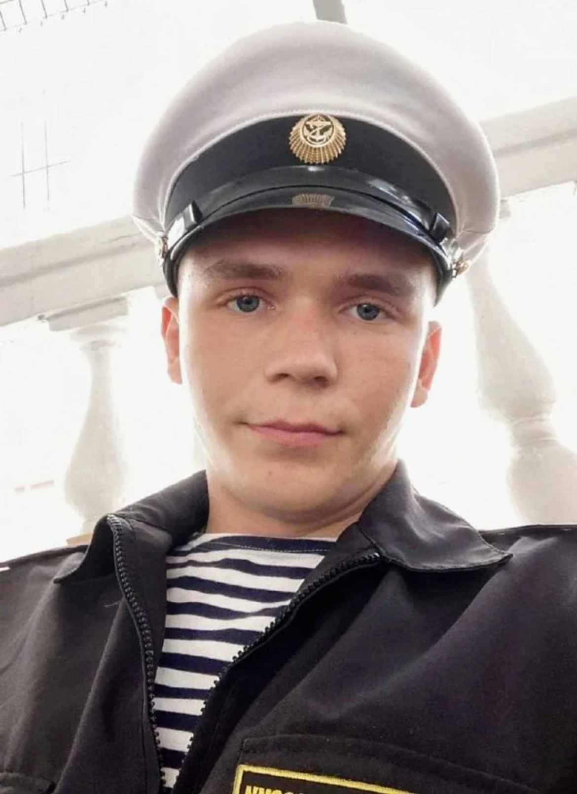 Black Sea coast line with a military ship silhouette in the distance, flag of the Russian Naval Infantry waving in the wind, powerful and stoic